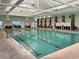 Indoor swimming pool for residents, well-lit with marked lanes and various seating options at 222 Westleton Dr. # 18D, Myrtle Beach, SC 29572