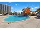 Resort style pool features a winding water slide and is surrounded by palm trees at 222 Westleton Dr. # 18D, Myrtle Beach, SC 29572