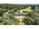 Captivating aerial view of a large brick estate surrounded by lush greenery, a golf course, and mature trees at 2264 Wedgefield Rd., Georgetown, SC 29440