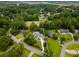 Stunning aerial view of landscaped property with pool, lush greenery, and golf course in the background at 2264 Wedgefield Rd., Georgetown, SC 29440