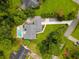 Aerial view of the property showcasing the house, pool, well-manicured lawn, and tree-lined surroundings at 2264 Wedgefield Rd., Georgetown, SC 29440