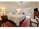 Spacious bedroom with a large bed, vintage rug and sitting area with lots of light at 2264 Wedgefield Rd., Georgetown, SC 29440