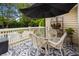 Charming deck area with a glass table, comfortable seating and a black umbrella overlooking the backyard pool at 2264 Wedgefield Rd., Georgetown, SC 29440