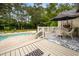 Inviting outdoor deck area with comfortable seating, perfect for relaxing by the sparkling swimming pool at 2264 Wedgefield Rd., Georgetown, SC 29440