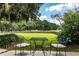 Inviting outdoor patio with table and chairs overlooking the golf course and lush green landscape at 2264 Wedgefield Rd., Georgetown, SC 29440