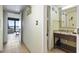 Bathroom with a modern vanity, granite countertop, and a doorway to the balcony at 2311 S Ocean Blvd. # 969, Myrtle Beach, SC 29577