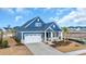 Aerial view of a blue two-story home with a two-car garage and manicured front yard at 2341 Hazel Way, Longs, SC 29568