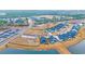 An aerial shot shows a blue home near a pond in a development with lush landscaping at 2341 Hazel Way, Longs, SC 29568