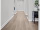 Bright hallway featuring hardwood floors and neutral walls at 2341 Hazel Way, Longs, SC 29568