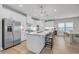 Bright kitchen with white cabinets, stainless steel appliances, large island, and hardwood floors at 2341 Hazel Way, Longs, SC 29568