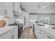 Modern kitchen featuring white cabinets, stainless steel appliances, and a spacious quartz countertop island at 2341 Hazel Way, Longs, SC 29568