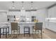 Modern kitchen with a large island, white cabinets, and stylish bar stools at 2341 Hazel Way, Longs, SC 29568