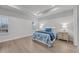 Main bedroom with a tray ceiling, hardwood floors, bright windows, and neutral paint at 2341 Hazel Way, Longs, SC 29568