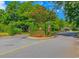 Welcoming entrance to a neighborhood with lush landscaping and American flags at 25 Berwick Dr., Pawleys Island, SC 29585