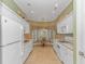 Bright kitchen featuring white cabinets, appliances, and a breakfast nook with a chandelier at 25 Berwick Dr., Pawleys Island, SC 29585