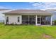 A home's backyard with a covered porch for outdoor relaxation and a well-maintained lawn at 2568 Goldfinch Dr., Myrtle Beach, SC 29577