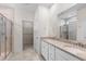 Bright bathroom featuring double sink vanity with granite countertops, a tiled shower and a walk-in closet at 2568 Goldfinch Dr., Myrtle Beach, SC 29577