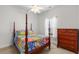 Bedroom with a four-poster bed, a window with curtains, and a dresser at 2568 Goldfinch Dr., Myrtle Beach, SC 29577