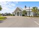 Exterior view of the community clubhouse with palm trees and beautiful landscaping at 2568 Goldfinch Dr., Myrtle Beach, SC 29577