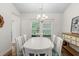 Bright dining room with a white table, chandelier, and neutral walls at 2568 Goldfinch Dr., Myrtle Beach, SC 29577