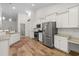 Spacious kitchen featuring stainless steel appliances, granite countertops, white cabinets and wood flooring at 2568 Goldfinch Dr., Myrtle Beach, SC 29577