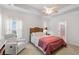 Main bedroom featuring wood furniture, tray ceilings, a ceiling fan, and an ensuite bathroom at 2568 Goldfinch Dr., Myrtle Beach, SC 29577