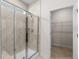 Modern tiled shower with glass door, overhead shower head, and a view into the walk-in closet at 2568 Goldfinch Dr., Myrtle Beach, SC 29577