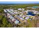 Aerial view of a community featuring colorful homes, a pond, and a community center at 301 Lumbee Circle, Pawleys Island, SC 29585