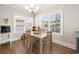 Bright dining area with a wooden table set, chandelier, and lots of natural light from windows at 301 Lumbee Circle, Pawleys Island, SC 29585