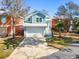 Charming two-story home featuring a light-blue exterior, a white garage door, and a well-manicured front yard at 301 Lumbee Circle, Pawleys Island, SC 29585