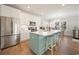 Stylish kitchen features white cabinets, a central island, stainless steel appliances, and bar stool seating at 301 Lumbee Circle, Pawleys Island, SC 29585