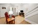 Inviting living room features a cozy couch, a vibrant red chair, and a staircase with white rails at 301 Lumbee Circle, Pawleys Island, SC 29585