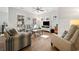 Cozy living room with striped sofas, a ceiling fan, and plenty of natural light at 301 Lumbee Circle, Pawleys Island, SC 29585