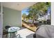 Relaxing patio space with seating and a grill, surrounded by lush greenery and trees at 301 Lumbee Circle, Pawleys Island, SC 29585