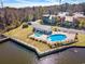 Aerial view of a community pool and lakefront area with docks and manicured landscaping at 301 Lumbee Circle, Pawleys Island, SC 29585