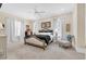 Spacious bedroom with a luxurious king-sized bed, soft carpet, and plenty of natural light from the windows at 3369 Collins Creek Dr., Murrells Inlet, SC 29576