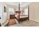 Bedroom featuring a four poster bed with colorful pillows and bedding, and natural light from the window at 3369 Collins Creek Dr., Murrells Inlet, SC 29576