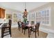 Elegant dining room features a wooden table, chairs, and a decorative chandelier and ample natural light at 3369 Collins Creek Dr., Murrells Inlet, SC 29576