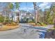 Elegant home boasts a grand entrance, lush landscaping, and a circular driveway at 3369 Collins Creek Dr., Murrells Inlet, SC 29576