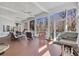 Large sunroom featuring multiple seating areas, ceiling fans, and a view of the wooded area at 3369 Collins Creek Dr., Murrells Inlet, SC 29576