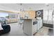 Cozy kitchen featuring white cabinets, light countertops, modern appliances and an adjacent living area at 351 Lake Arrowhead Rd. # 2-206, Myrtle Beach, SC 29572