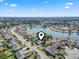 Aerial view of a residential neighborhood with homes surrounding a central lake and manicured lawns at 356 Carriage Lake Dr., Little River, SC 29566