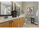 Bathroom with a double sink, light wood cabinets, and neutral-toned walls and flooring at 356 Carriage Lake Dr., Little River, SC 29566