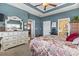 Cozy bedroom with blue walls, ceiling fan, and decorative white dresser with ornate mirror at 356 Carriage Lake Dr., Little River, SC 29566