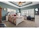 Cozy bedroom with a decorative bed frame and a tray ceiling with ceiling fan at 356 Carriage Lake Dr., Little River, SC 29566