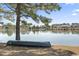 Picturesque lake view with a canoe resting on the shore in a serene residential neighborhood at 356 Carriage Lake Dr., Little River, SC 29566