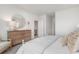 Cozy bedroom featuring a large round mirror, wood dresser, and neutral colors at 365 Rookroost Circle, Conway, SC 29526