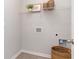 Bright laundry room with a wire shelf above washer hookups, offering convenient storage solutions at 365 Rookroost Circle, Conway, SC 29526