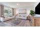 Light-filled living room with a cozy seating arrangement, natural accents and a rustic media console at 365 Rookroost Circle, Conway, SC 29526