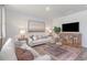 Bright living room with a comfortable seating arrangement, stylish rug and wooden media cabinet at 365 Rookroost Circle, Conway, SC 29526